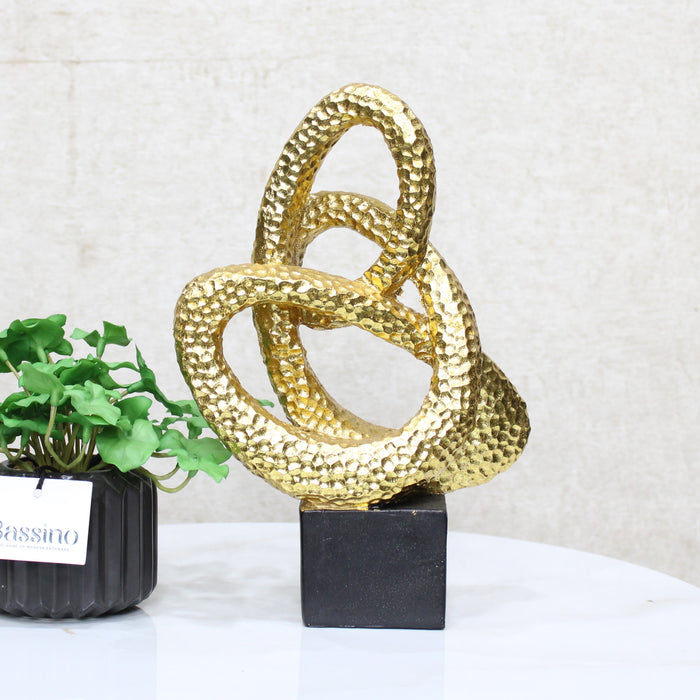 Gold Spiral Loop Sculpture, designed with a hammered-texture finish The abstract spiral form adds movement and dimension, making it an eye-catching accent for console tables, bookshelves, or office desks. BSP-8215 L 18 W 7 H 26
