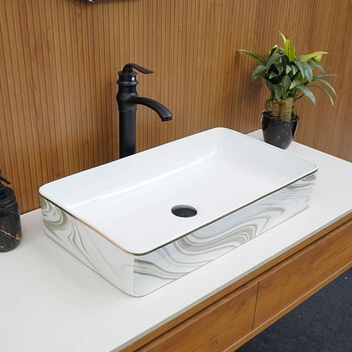 White rectangular sink with black faucet and plant on wooden countertop