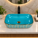 455x325x140 mm turquoise blue ceramic table top wash basin with glossy finish, gold geometric pattern and decorative rim for modern luxury bathrooms.