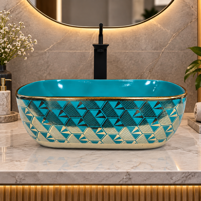 455x325x140 mm turquoise blue ceramic table top wash basin with glossy finish, gold geometric pattern and decorative rim for modern luxury bathrooms.