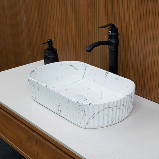 Marble-textured sink with black faucet and soap dispenser on a wooden wall background