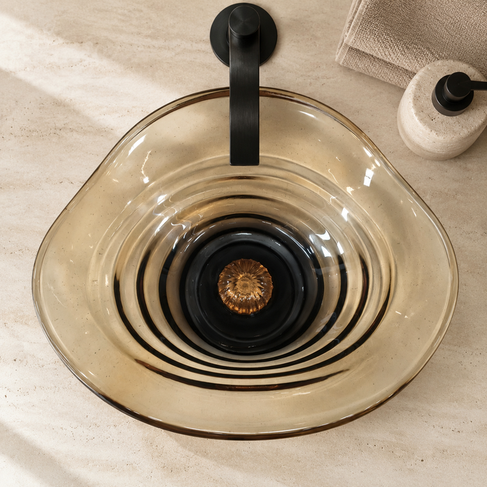 Amber sculptural glass table top wash basin with layered contours, smoky-Orange centre and matching glass waste coupling.