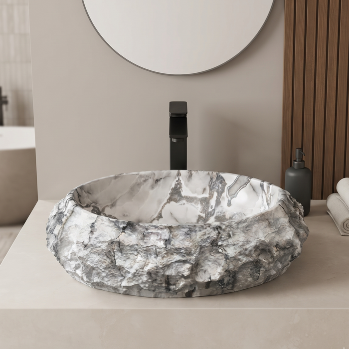 Artificial stone table top wash basin with white and grey marble finish, rugged rock texture and oval design, 500 × 400 × 150 mm.