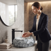 Artificial stone table top wash basin with white and grey marble finish, rugged rock texture and oval design, 500 × 400 × 150 mm.