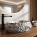 Artificial stone table top wash basin with white and grey marble finish, rugged rock texture and oval design, 500 × 400 × 150 mm.