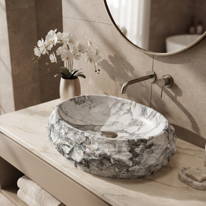 Artificial stone table top wash basin with white and grey marble finish, rugged rock texture and oval design, 500 × 400 × 150 mm.