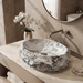 Artificial stone table top wash basin with white and grey marble finish, rugged rock texture and oval design, 500 × 400 × 150 mm.