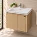 Bassino 600 mm wall-mounted bathroom vanity with glossy white ceramic basin, natural oak PVC cabinet, stainless-steel support and two-door storage.