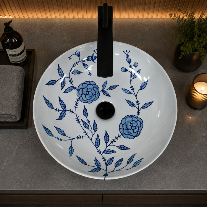 Bassino handmade ceramic table top wash basin 400 × 400 × 120 mm with blue floral pattern, white glossy finish and round countertop design for modern bathrooms.