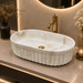 Bassino premium oval ceramic table top wash basin with matte ivory marble design