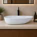 Bassino white marble pattern table top wash basin 560 × 355 × 130 mm with asymmetrical oval design for modern luxury bathroom countertops.