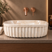 Beige marble ceramic table top wash basin with glossy finish, fluted exterior and elongated oval design, 550 × 350 × 150 mm.