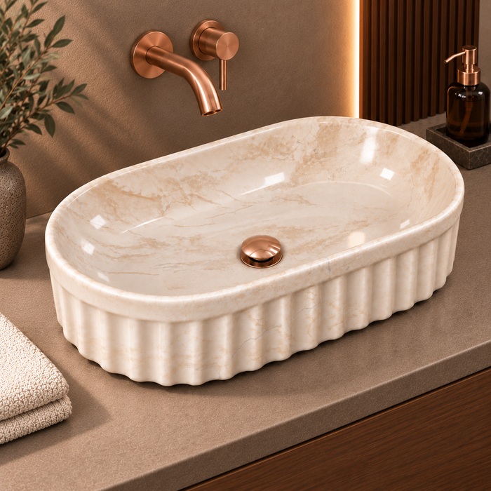 Beige marble ceramic table top wash basin with glossy finish, fluted exterior and elongated oval design, 550 × 350 × 150 mm.