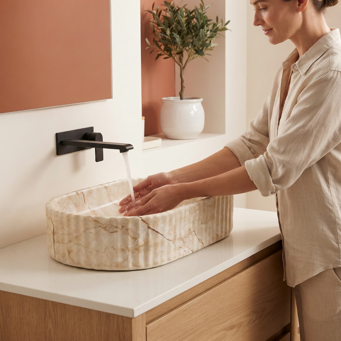 Beige marble fluted ceramic table top wash basin, 510x310x120 mm, with oval oblong shape and ribbed exterior for modern luxury bathrooms.