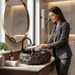 Black and gold artificial stone table top wash basin with matte finish, oval shape and natural rock textured exterior, 560 × 480 × 135 mm.