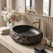 Black and gold artificial stone table top wash basin with matte finish, oval shape and natural rock textured exterior, 560 × 480 × 135 mm.