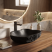 Black artificial stone table top wash basin with organic free-form shape, rough rock-textured exterior and 490 × 370 × 140 mm size.