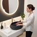 Black stone texture oval ceramic table top wash basin 500x375x150 mm with white marble veining and rough rock exterior for luxury bathrooms.