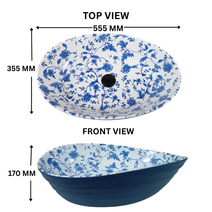 Blue and white floral ceramic table top wash basin with glossy finish, oval designer countertop basin measuring 555 × 355 × 170 mm for modern bathrooms.