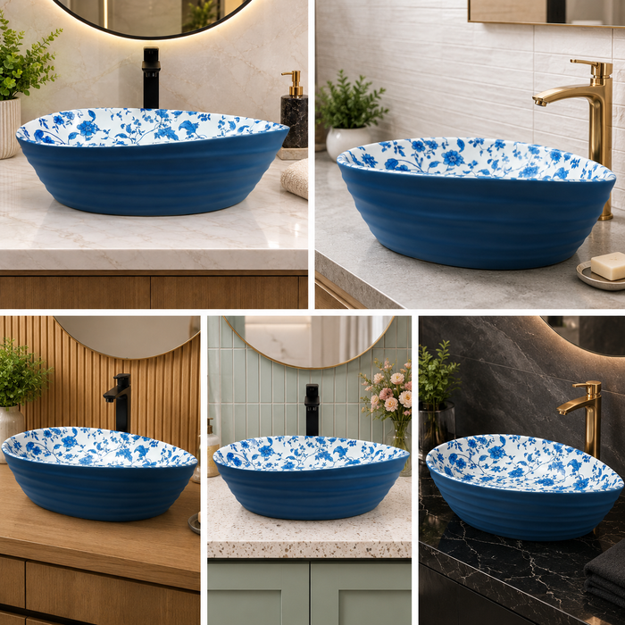 Blue and white floral ceramic table top wash basin with glossy finish, oval designer countertop basin measuring 555 × 355 × 170 mm for modern bathrooms.