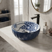 Blue and white floral round ceramic table top wash basin 375x375x125 mm with matte finish and sculpted fluted exterior design.