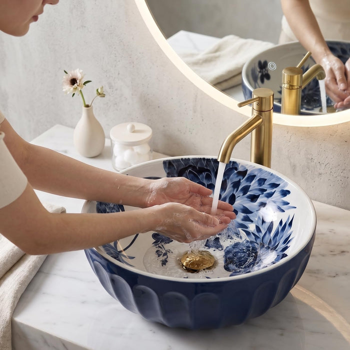 Blue and white floral round ceramic table top wash basin 375x375x125 mm with matte finish and sculpted fluted exterior design.