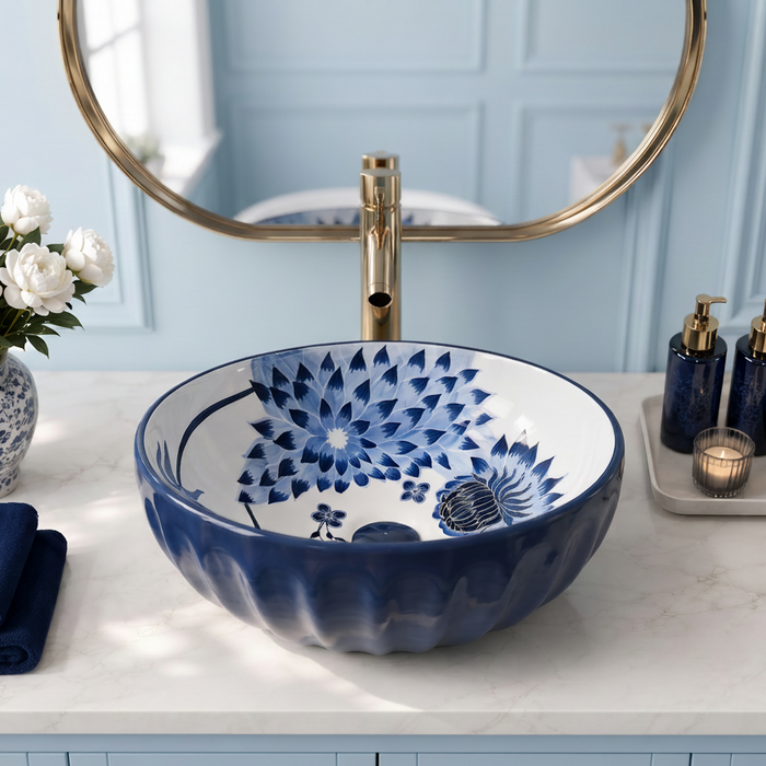 Blue and white floral round ceramic table top wash basin 375x375x125 mm with matte finish and sculpted fluted exterior design.
