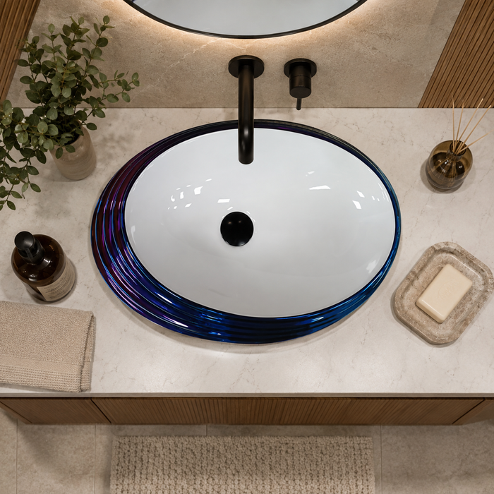 Blue and white glossy ceramic table top wash basin with oval layered design, 520 × 380 × 150 mm designer countertop basin for modern luxury bathrooms.