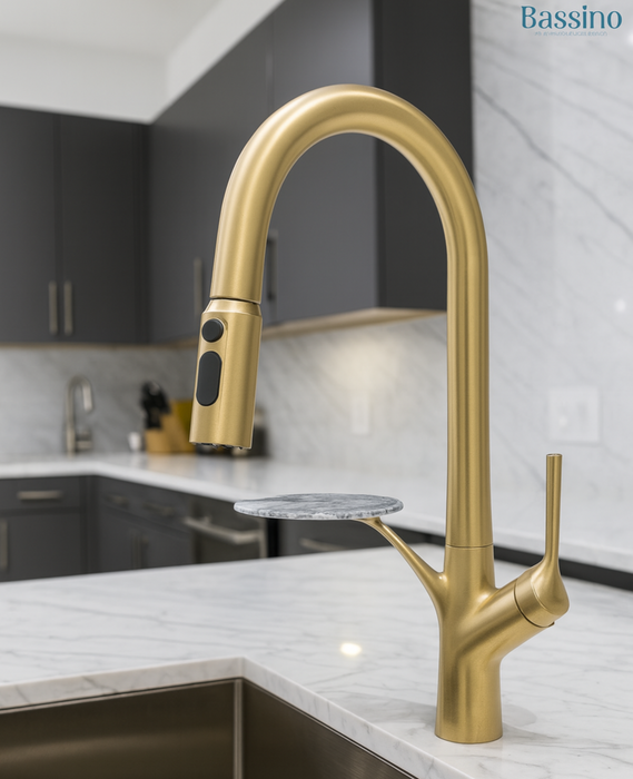 Gold kitchen faucet on a modern kitchen counter with 'Bassino' branding.
