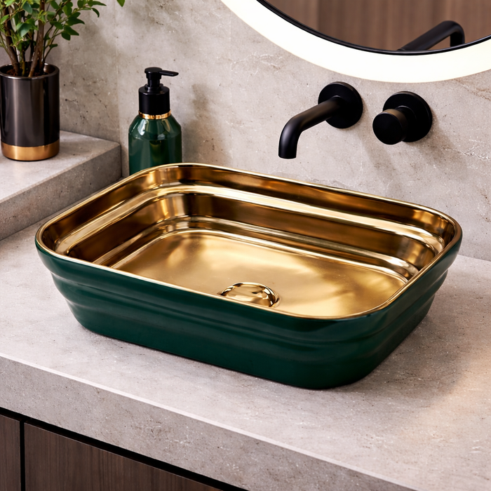 Green and gold sink on a bathroom counter with a mirror and soap dispenser.