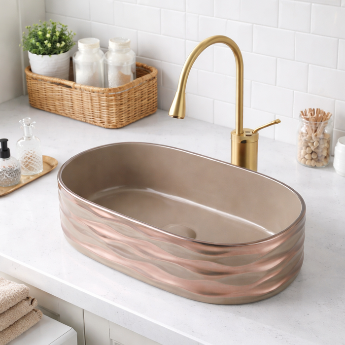 Bronze sink on a white countertop with a gold faucet