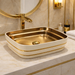 Luxurious bathroom vanity with gold and white sink, mirror, and toiletries.