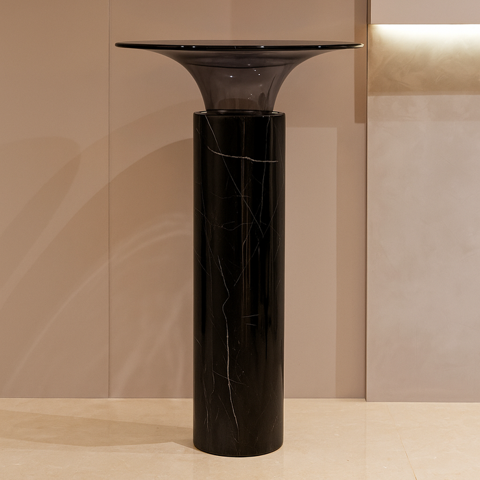 Black marble pedestal against a beige wall