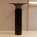 Black marble pedestal against a beige wall