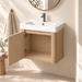 Compact light-wood wall-mounted bathroom vanity with integrated white basin and single-door storage
