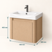 Compact light-wood wall-mounted bathroom vanity with integrated white basin and single-door storage