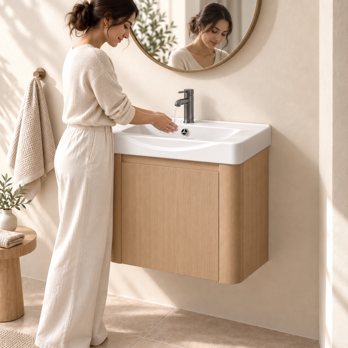 Compact light-wood wall-mounted bathroom vanity with integrated white basin and single-door storage