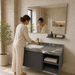 Dark grey wall-mounted bathroom vanity set with marble-finish countertop, white basin, mirror and matching wall-mounted utility shelf.