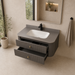 Floating grey bathroom vanity with two drawers, gold knobs and white basin