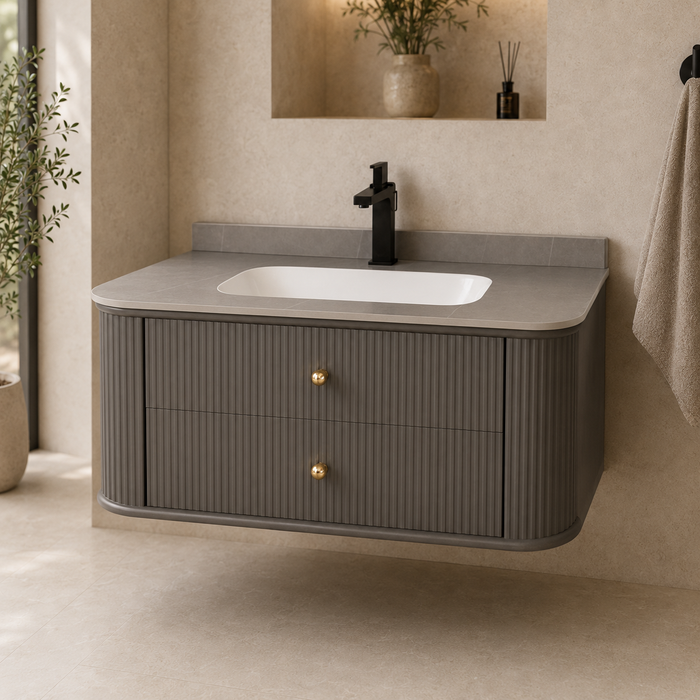 Floating grey bathroom vanity with two drawers, gold knobs and white basin
