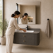 Floating grey bathroom vanity with two drawers, gold knobs and white basin