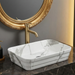 Marble-patterned sink with gold faucet and mirror in a bathroom setting
