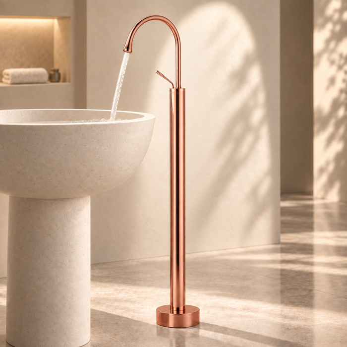 Glossy Rose gold floor mount basin faucet with tall curved spout and single lever handle, modern freestanding bathroom tap for luxury wash basin installations by Bassino.