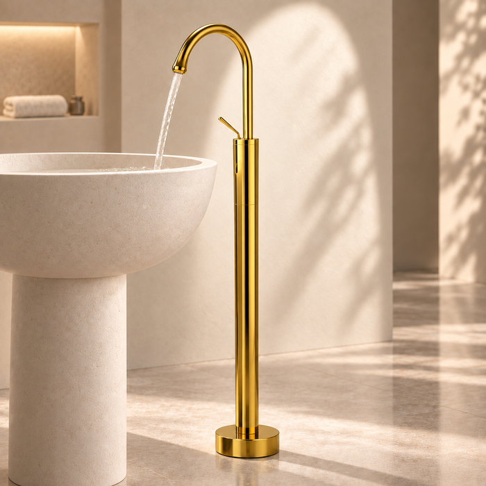 Glossy gold floor mount basin faucet with tall curved spout and single lever handle, modern freestanding bathroom tap for luxury wash basin installations by Bassino.