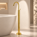Glossy gold floor mount basin faucet with tall curved spout and single lever handle, modern freestanding bathroom tap for luxury wash basin installations by Bassino.
