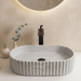 Grey marble fluted ceramic table top wash basin, 510x310x120 mm, with ribbed rounded rectangular design for modern bathrooms.