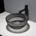 Black textured sink with black faucet on a white countertop against a gray wall.