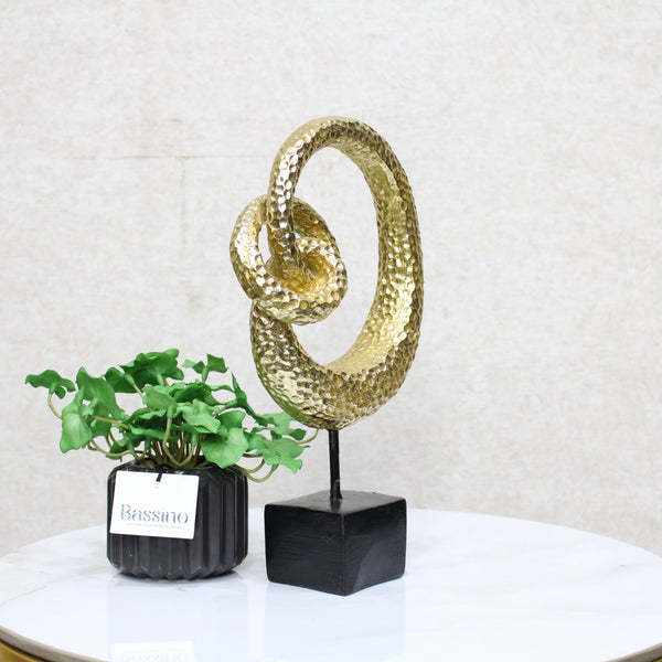 Gold Spiral Loop Sculpture, designed with a hammered-texture finish The abstract spiral form adds movement and dimension, making it an eye-catching accent for console tables, bookshelves, or office desks. BSP-8216 L 18 W 7 H 29