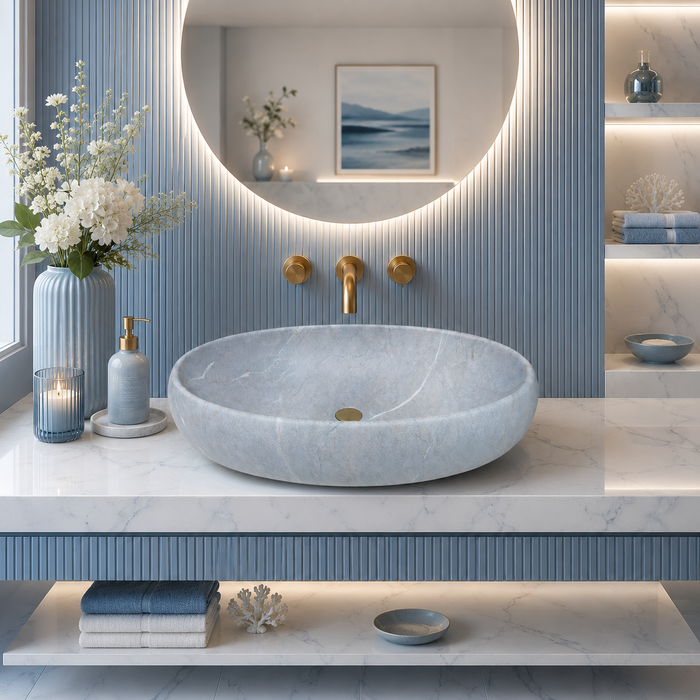 Light blue Ceramic finish oval table top wash basin, 600x400x150 mm, displayed in a modern luxury bathroom setting.