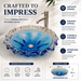 Luxury blue crystal glass table top wash basin with sculpted wavy edges, 420 × 420 × 130 mm, displayed in a modern bathroom.